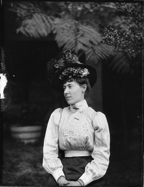 A woman in a hat and blouse. A woman in a hat and blouse.