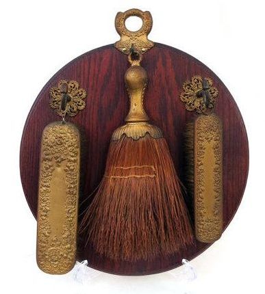 A vintage brush and mirror set made of wood and brass. A vintage brush and mirror set made of wood and brass.