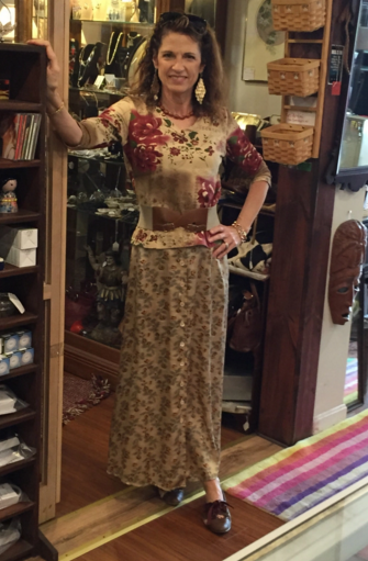 Photo of a woman in a floral top and a long skirt Photo of a woman in a floral top and a long skirt