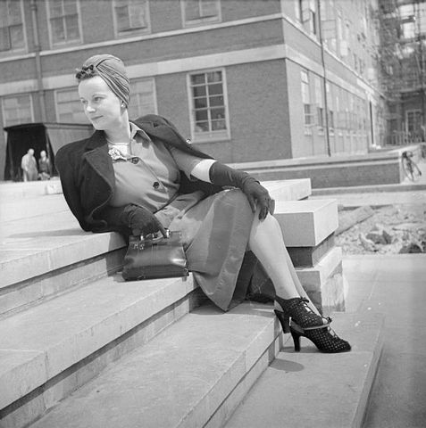 Black and white photo of a woman sitting on a set of stairs. Black and white photo of a woman sitting on a set of stairs.